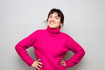 Portrait of   emotional young woman in  pink  sweater.