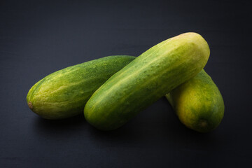 fresh green zucchini, also known as courgette or baby marrow, versatile vegetable isolated on dark background