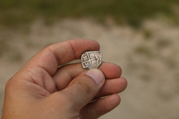 Silver european coin of middle ages in hand