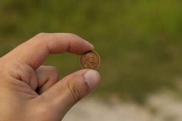 Vintage coin one cent in hand