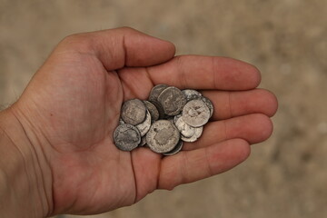 Ancient Roman silver coins in hand