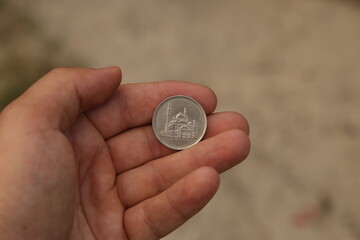 Old arab coin in hand