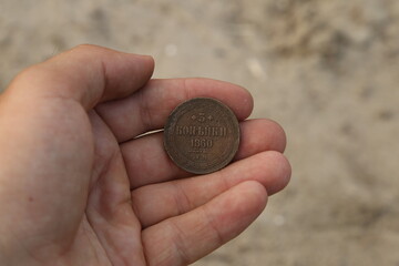 Old Russian copper coin in hand