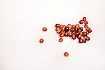 Bunch of ripe claret table grapes viewed from the top on white studio background