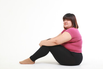Fototapeta premium asian fat woman wear workout clothes sitting on a white background. health care concept, weight loss for good health