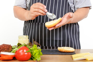 fat man cooking Hold bread and butter to make hamburgers. The concept of cooking to lose weight, eat healthy food. white background