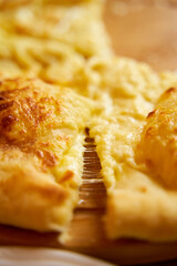 Hot khachapuri in Imeretian style. Stretching processed cheese. Incredibly delicious dish