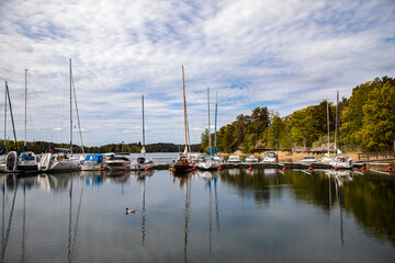 Fototapeta na wymiar Gustavsberg. Blue cloudy sky over lake, boats and yachts
