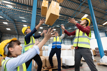 factory workers throwing boxes for success the project in warehouse storage