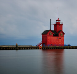 Big Red Lighthouse at the entrance to Macatawa lake and bay on Lake Michigan