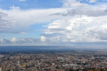 Aerial view of Blida city on a cloudy day from Chrea National Park, Algeria.