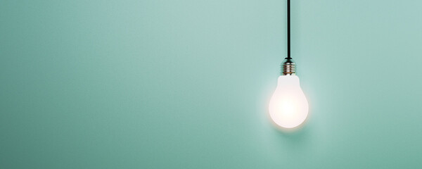 One hanging light bulb glowing on blue background for creative thinking idea and innovation concept...