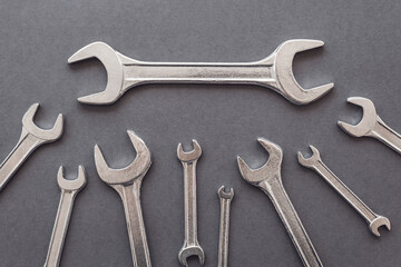 flat lay of set of spanners and wrench on blue grey background. Repairing tools.
