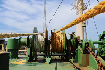 Mooring winch of large ship with white rope in drum.