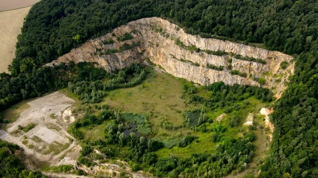 Abandoned lime stone quarry pit, Aerial Drone view in 4k, recultivation / renaturation