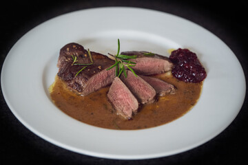 ready to eat, the roasted topside from a young roe deer in wine mustard sauce and cranberry jam