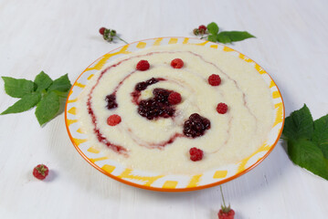 Yellow pate with semolina, raspberry, jam and butter on white background