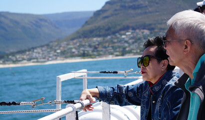 Asian senior elderly couple on tourist ferry boat to seals island trip attracion Fun wildlife...