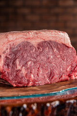 Raw strip loin beef (argentine chorizo) on a wood resined cutting board - Closeup.