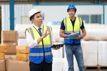 factory worker or engineer using tablet for preparing a job in warehouse storage