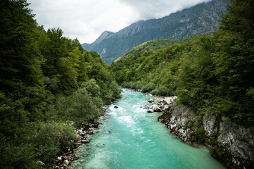 Fototapeta na wymiar Blue Soča river with crystal clear water in the Soča valley (Slovenia)