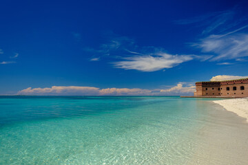 The crystal clear waters of the Gulf of Mexico surround Civil War Historic Fort Jefferson in the Dry Tortugas - obrazy, fototapety, plakaty
