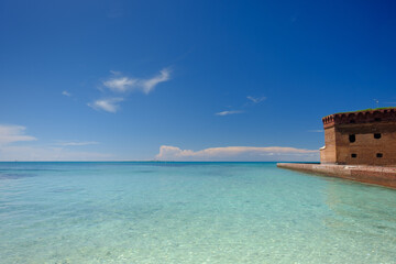 The crystal clear waters of the Gulf of Mexico surround Civil War Historic Fort Jefferson in the Dry Tortugas - obrazy, fototapety, plakaty