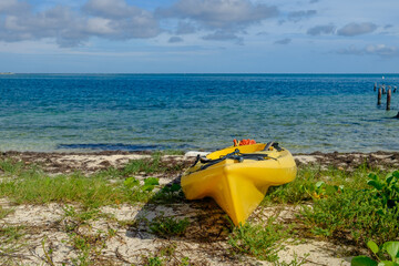 Bright Yellow Sea Kayak sits on the shore of the crystal clear waters of the Dry Tortugas in the...