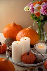 Autumn centrepiece, candles, autumn flowers and pumpkins