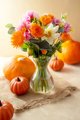 Autumn flowers and pumpkins, fall warm backdrop