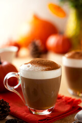 Closeup cups of pumpkin autumn latte warm drink with whipped cream. Autumn cozy beverage.