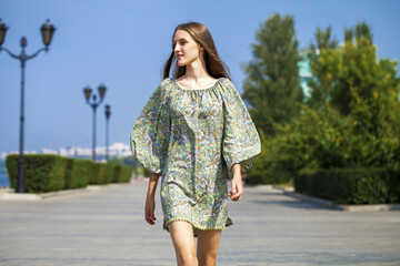 Young beautiful brunette girl in summer dress
