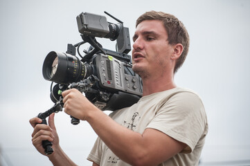 Behind the scene. Cameraman shooting film scene with his camera