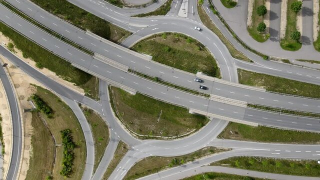 Aerial of roundabout low traffic , motorway in Regensburg Germany Europe in 4k, intersection with exit, slip road to parking lot, few cars, drone