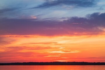Naklejka na ściany i meble Lake Musov - South Moravia - Czech Republic. Calm water at sunset. Beautiful clouds in the sky.