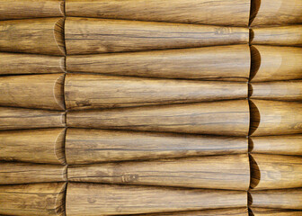 Traditional ecological consistent cladding of a wall with brown wooden larch fish scales, wood shingles, clapboard, clapboard texture background