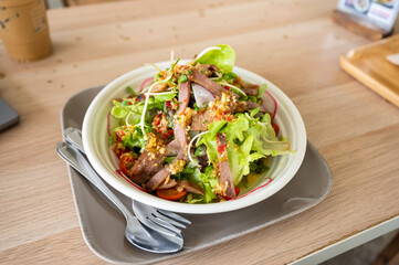Spicy vegetables with pork salad in white dish