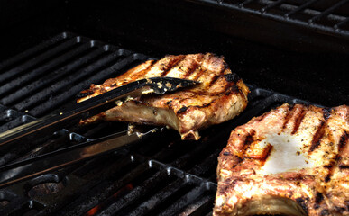 Fresh grilled pork meat. Grilling steaks on flaming grill. 
