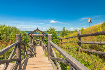 A wooden staircase from Mount Levitan with a view of the Volga River in Plyos