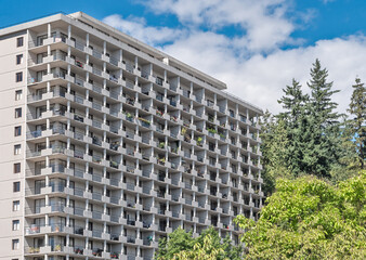 Back side of apartment residential building on blue sky background