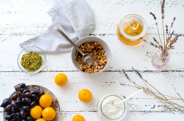 Breakfast concept with granola, honey, yogurt and fruits