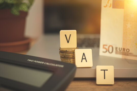 VAT text on business desktop with laptop and calculator for calculating the taxes in Europe union, business and management economic background photo