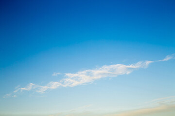 Beautiful blue sky with a white cloud in the form of a DNA helix. Sky panorama for screensavers,...