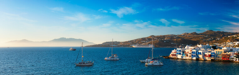 Sunset in Mykonos, Greece, with cruise ship and yachts in the harbor