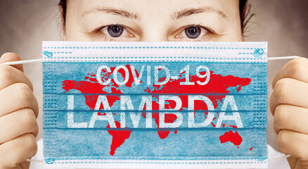 Face mask in hand with inscription Covid-19 LAMBDA . Covid 19 alpha, beta, gamma, delta, lambda variants outbreak around the world