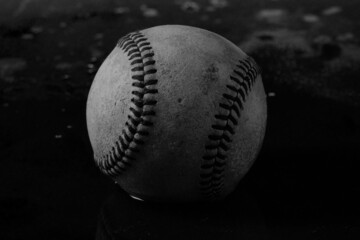 Fototapeta na wymiar baseball on black texture background