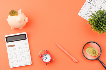 Piggy bank with calculators office desk top view.