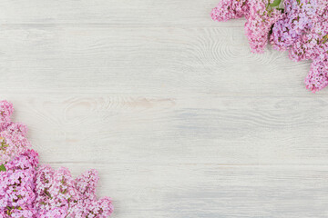 White wooden background with lilac.