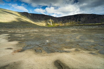 The cracked bottom of a dried mountain lake