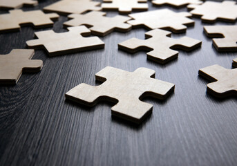 puzzle elements on a wooden background as a riddle